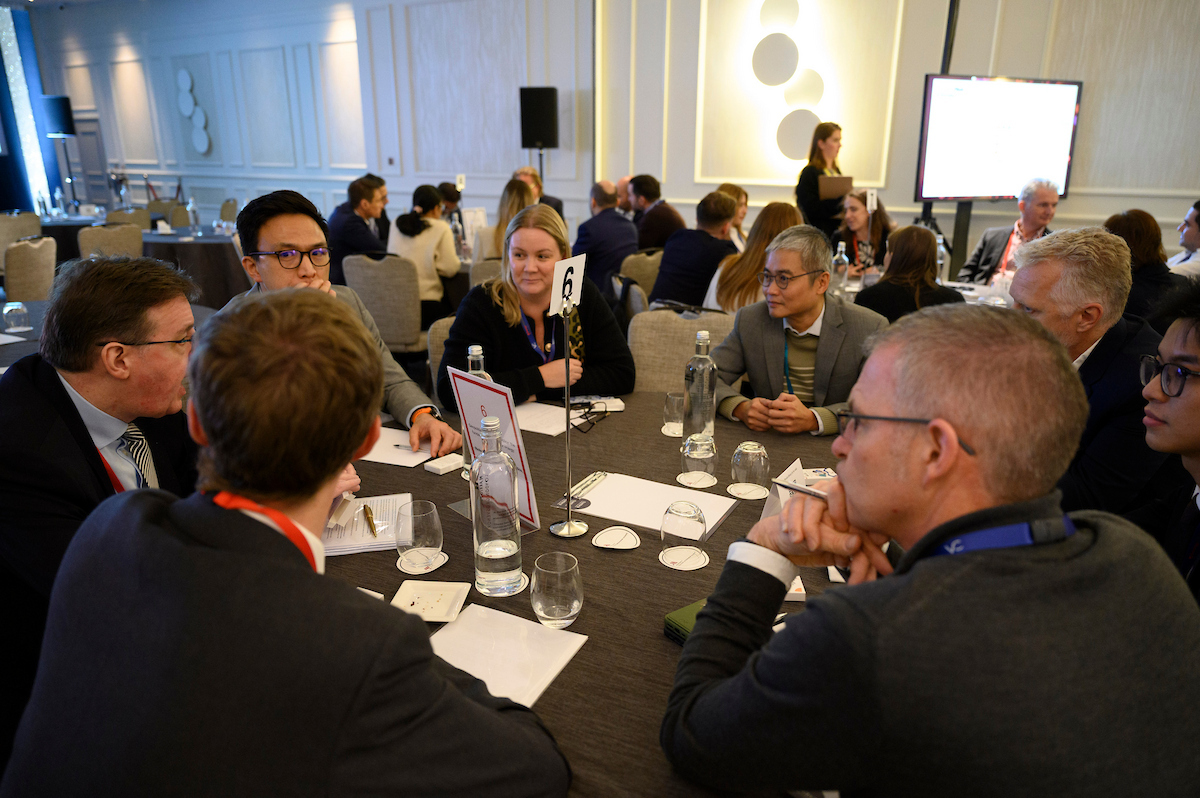 Energy Risk Europe attendees talking to event sponsors at a sponsorship booth