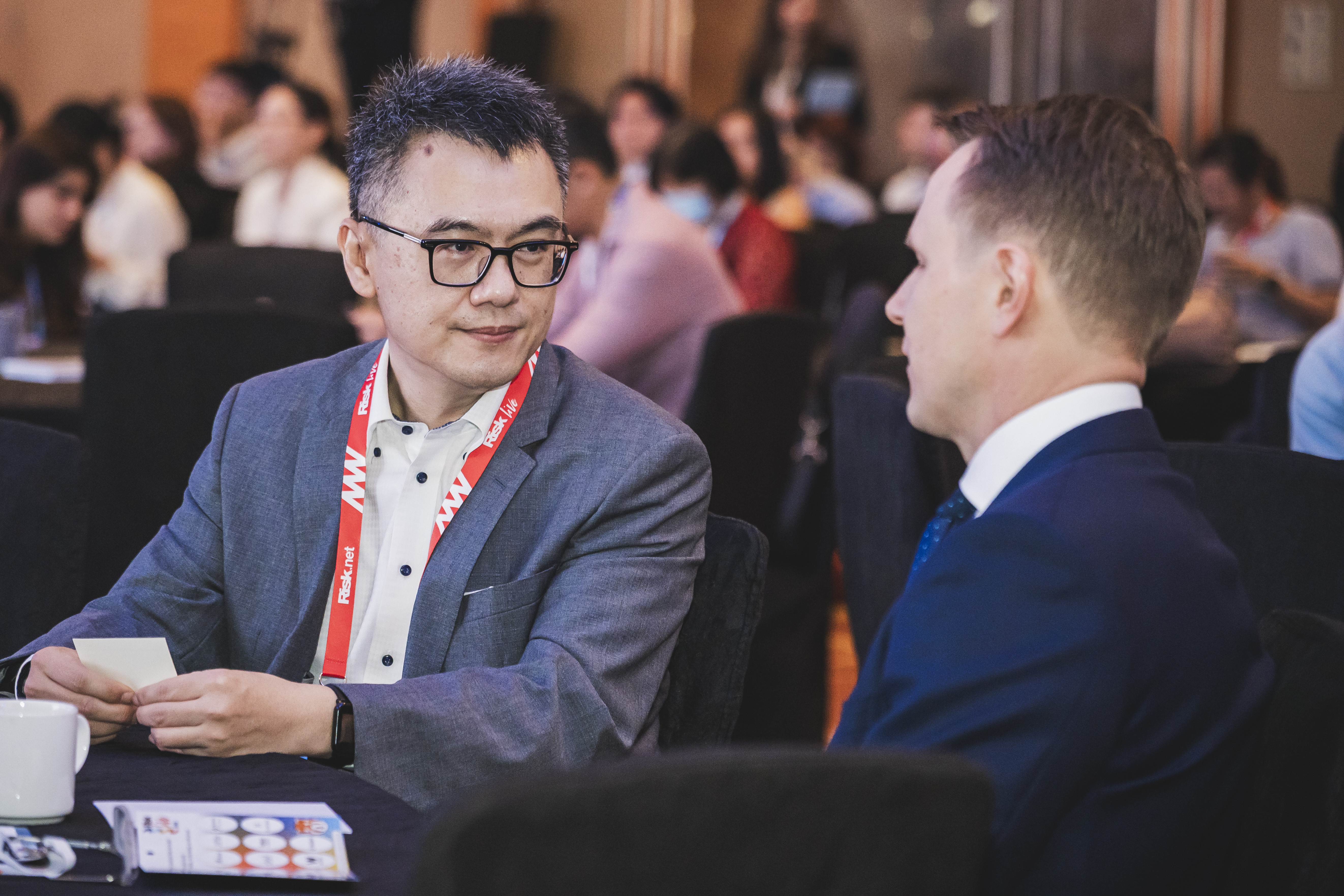 Energy Risk USA audience watching a panel session with four people speaking on stage